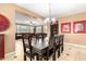 Formal dining room with a dark wood table, with views into other living spaces at 5312 N Sierra Hermosa Ct, Litchfield Park, AZ 85340