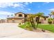 Stunning home featuring a three-car garage, beautiful stonework, and desert landscaping at 5312 N Sierra Hermosa Ct, Litchfield Park, AZ 85340