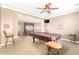 An expansive game room featuring a pool table, bar stools, and an entertainment area at 5312 N Sierra Hermosa Ct, Litchfield Park, AZ 85340