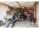 Large garage with a yellow golf cart and bikes at 5312 N Sierra Hermosa Ct, Litchfield Park, AZ 85340
