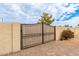 Elegant black metal gate securing the property, enhancing privacy and curb appeal with its timeless design at 5312 N Sierra Hermosa Ct, Litchfield Park, AZ 85340