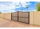 Sturdy black metal gate providing security and style, complementing the surrounding landscape and architecture at 5312 N Sierra Hermosa Ct, Litchfield Park, AZ 85340