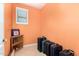 Small hallway with orange walls, tiled floor, and a row of luggage at 5312 N Sierra Hermosa Ct, Litchfield Park, AZ 85340