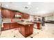 Open concept kitchen with stainless steel appliances, ample counter space, and lots of cabinets at 5312 N Sierra Hermosa Ct, Litchfield Park, AZ 85340