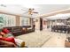 Open-concept living area with hardwood floors, a large sectional sofa, and dining space at 5312 N Sierra Hermosa Ct, Litchfield Park, AZ 85340