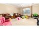 playroom with ceiling fan, window with shutters, and multiple seating options at 5312 N Sierra Hermosa Ct, Litchfield Park, AZ 85340