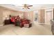 Spacious main bedroom featuring a king-size bed, a seating area, and neutral carpeting at 5312 N Sierra Hermosa Ct, Litchfield Park, AZ 85340