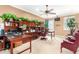 Home office with wooden desk, cabinets, ceiling fan, and outdoor view at 5312 N Sierra Hermosa Ct, Litchfield Park, AZ 85340