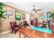 Inviting home office with a ceiling fan, rich wood desk, leather chairs, and charming sports memorabilia at 5312 N Sierra Hermosa Ct, Litchfield Park, AZ 85340