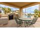 Relaxing outdoor dining area with a grill and a view of the refreshing pool, perfect for al fresco meals at 5312 N Sierra Hermosa Ct, Litchfield Park, AZ 85340