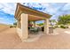 Entertain outdoors with this charming covered kitchen featuring a built-in grill, stone accents, and ample seating at 5312 N Sierra Hermosa Ct, Litchfield Park, AZ 85340