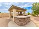Charming outdoor kitchen with stone accents, covered area, and grill, perfect for outdoor entertaining at 5312 N Sierra Hermosa Ct, Litchfield Park, AZ 85340