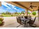 Inviting covered patio featuring a dining table and chairs, perfect for outdoor entertaining and relaxation at 5312 N Sierra Hermosa Ct, Litchfield Park, AZ 85340