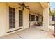 Spacious covered patio with ceiling fans for comfortable outdoor living, featuring access to the backyard at 5312 N Sierra Hermosa Ct, Litchfield Park, AZ 85340