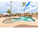 Enjoy this inviting outdoor pool with a built-in jacuzzi, lounge chairs, and swaying palm trees for a resort-like experience at 5312 N Sierra Hermosa Ct, Litchfield Park, AZ 85340