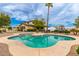 Inviting backyard swimming pool with lounge chairs and lush landscaping at 5312 N Sierra Hermosa Ct, Litchfield Park, AZ 85340