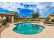 Sparkling pool with attached hot tub, covered patio, and well-manicured backyard at 5312 N Sierra Hermosa Ct, Litchfield Park, AZ 85340