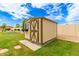 Outdoor storage shed with neutral color scheme, offering practical and secure storage solutions in the backyard at 5312 N Sierra Hermosa Ct, Litchfield Park, AZ 85340