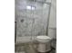 Updated bathroom with marble tile shower and gray floor tile at 2209 E Sheridan St, Phoenix, AZ 85006