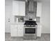 Modern kitchen with white cabinets, stainless steel appliances, and gray tile at 2209 E Sheridan St, Phoenix, AZ 85006