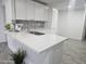 Modern kitchen with white cabinets and gray tile backsplash at 2209 E Sheridan St, Phoenix, AZ 85006