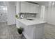 Modern kitchen with white cabinets, island, and gray tile floor at 2209 E Sheridan St, Phoenix, AZ 85006