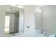 Spacious bathroom with double vanity, large mirrors, and a glass-enclosed shower at 9127 W Banff Ln, Peoria, AZ 85381