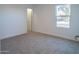 Well-lit bedroom with new carpet and window at 9127 W Banff Ln, Peoria, AZ 85381