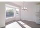 Bright dining room with large window and modern chandelier at 9127 W Banff Ln, Peoria, AZ 85381