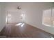 Bright living room featuring hardwood floors and large windows at 9127 W Banff Ln, Peoria, AZ 85381