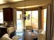 Bright breakfast nook with round table and view of backyard pool at 21956 N 59Th Ln, Glendale, AZ 85310