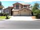 Two-story house with three-car garage and landscaped front yard at 21956 N 59Th Ln, Glendale, AZ 85310