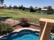Relaxing pool view with golf course and lake in the background at 21956 N 59Th Ln, Glendale, AZ 85310
