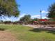 Green grassy area with playground and covered pavilion at 36813 W La Paz St, Maricopa, AZ 85138