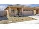 Charming single-story home featuring a neutral color scheme, a two-car garage, and desert landscaping at 6468 S 246Th Ln, Buckeye, AZ 85326