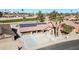 Aerial view of a house with solar panels, located near a golf course at 18822 N Grandview Dr, Sun City West, AZ 85375