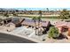 Aerial view of a house with solar panels, a driveway, and a golf course nearby at 18822 N Grandview Dr, Sun City West, AZ 85375