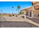 Side yard with gravel, walkway, and partial view of golf course at 18822 N Grandview Dr, Sun City West, AZ 85375