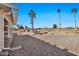 Landscaped backyard with gravel and partial view of golf course at 18822 N Grandview Dr, Sun City West, AZ 85375