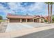 Tan one-story home with solar panels and a two-car garage at 18822 N Grandview Dr, Sun City West, AZ 85375