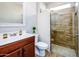 Well lit bathroom with a wood-look tile shower and neutral toned walls at 42531 W Heavenly Pl, Maricopa, AZ 85138