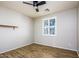 Light bedroom with wood-look floors, neutral walls, and a window with shutters at 42531 W Heavenly Pl, Maricopa, AZ 85138