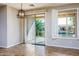 Dining area with sliding glass doors that offer access to an outdoor patio overlooking the pool at 42531 W Heavenly Pl, Maricopa, AZ 85138