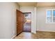 Welcoming entryway with wood-look floors, showing a security door and an open view to the outside at 42531 W Heavenly Pl, Maricopa, AZ 85138