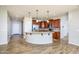 Modern kitchen featuring a breakfast bar, stainless steel appliances, and rich wood cabinetry at 42531 W Heavenly Pl, Maricopa, AZ 85138