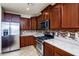 Updated kitchen featuring stainless steel appliances, granite countertops, and mosaic backsplash at 42531 W Heavenly Pl, Maricopa, AZ 85138