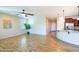 Open-concept living room with wood-look floors seamlessly connecting to the modern kitchen area at 42531 W Heavenly Pl, Maricopa, AZ 85138