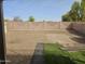 The spacious backyard contains gravel, with small patches of artificial turf and a brick wall at 2104 E 36Th Ave, Apache Junction, AZ 85119