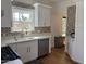 Well-lit kitchen with stainless steel appliances, white cabinets, and a decorative backsplash at 73 W Lewis Ave, Phoenix, AZ 85003
