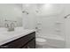 Bathroom featuring a vanity, mirror, toilet, and tub with white tile surround, offering modern comfort at 4505 S Mole --, Mesa, AZ 85212